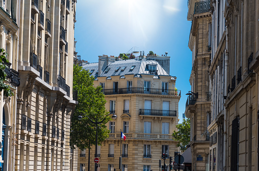 Sun shining over elegant buildings in Paris, France