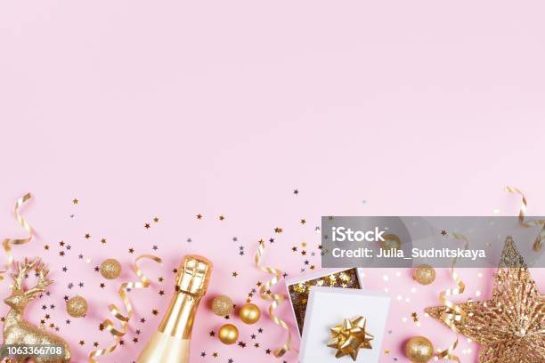 Christmas Background With Golden Gift Or Present Box Champagne And Holiday Decorations On Pink Pastel Table Top View Stock Photo - Download Image Now