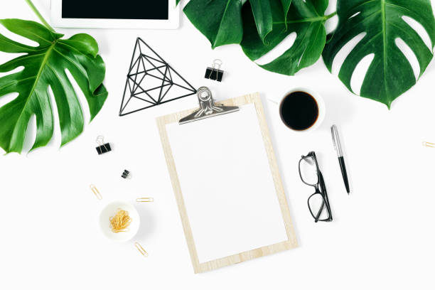 istock Modern white office desk table clipboard monstera leaves accessories flat lay top view 1063367572