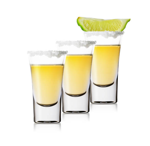 istock Three glasses of golden tequila standing in row 1063367800