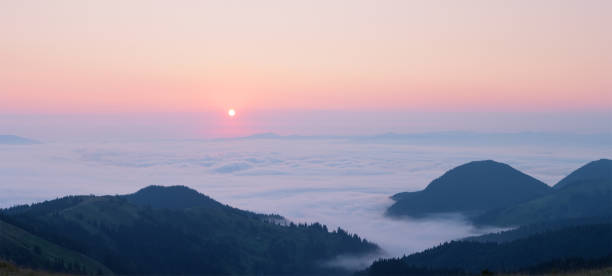 istock Pink dawn above the clouds in the mountains 1063369510