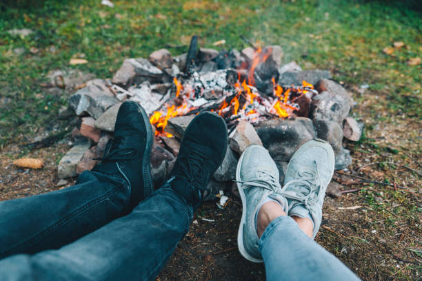 istock leg of two persons in front of camp fire 1063370044