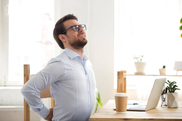 istock Businessman sitting in office has a backache 1063372156