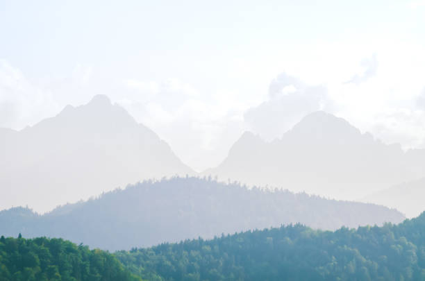 Alps skyline from above Turin bathed in fog and/or smog with smokestack emitting smoke