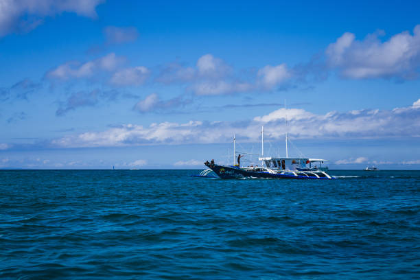 Malay, Philippines - January 12, 2016: a double outrigger wooden boat on the sea around Boracay, on the municipality of Malay, Philippines.