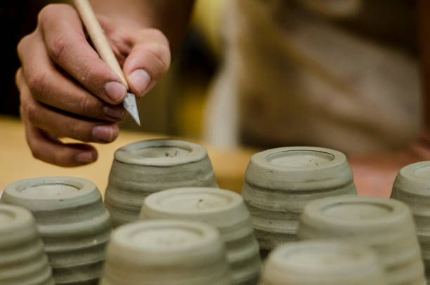 istock A woman signs her freshly made ceramic cups 1063376050