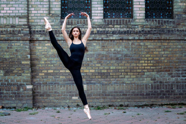 istock Young ballet dancer on the street taking art performance 1063376478