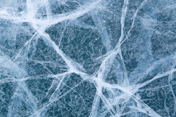 cracked texture of ice on Baikal lake, Winter stock photo