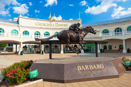 Louisville, Kentucky, USA - August 16, 2015:  Churchill Downs in Louisville, Kentucky with a statue of the Kentucky Derby winning horse, Barbaro.