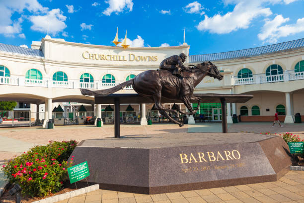 Churchill Downs In Louisville, Kentucky Louisville, Kentucky, USA - August 16, 2015:  Churchill Downs in Louisville, Kentucky with a statue of the Kentucky Derby winning horse, Barbaro. louisville kentucky stock pictures, royalty-free photos & images