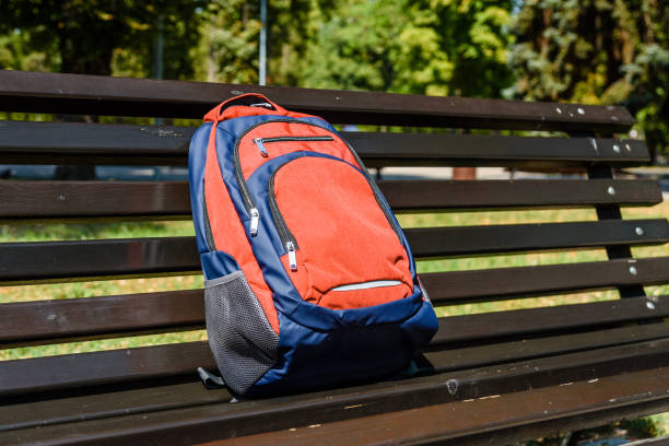 istock Tourist backpack on a bench in city park 1063387950