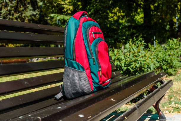 istock Tourist backpack on a bench in city park 1063387954