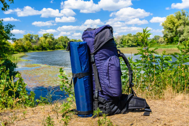 istock Touristic backpack on a bank of river 1063388010