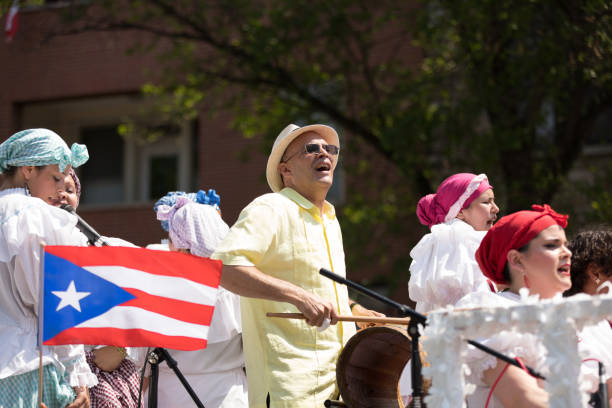 The Puerto Rican People's Parade Chicago, Illinois, USA - June 16, 2018: The Puerto Rican People's Parade, puerto rican people with traditional clothing, singing and playing bomba music with barril de bomba puerto rican ethnicity stock pictures, royalty-free photos & images