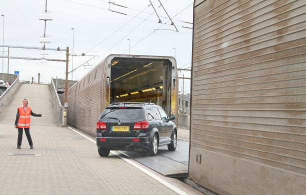 Folkestone, Kent, UK,11th of July 2018, cars about to board the eurostar trains for the Channel Tunnel crossing between France and England, euro tunnel employee is directing vehicles safely aboard train