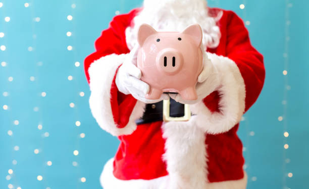 istock Santa holding a piggy bank 1063400038