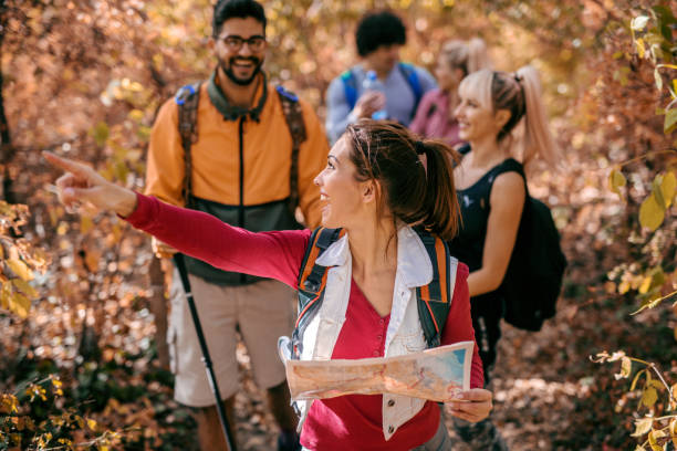 istock Woman leading other hikers in woods. 1063400826