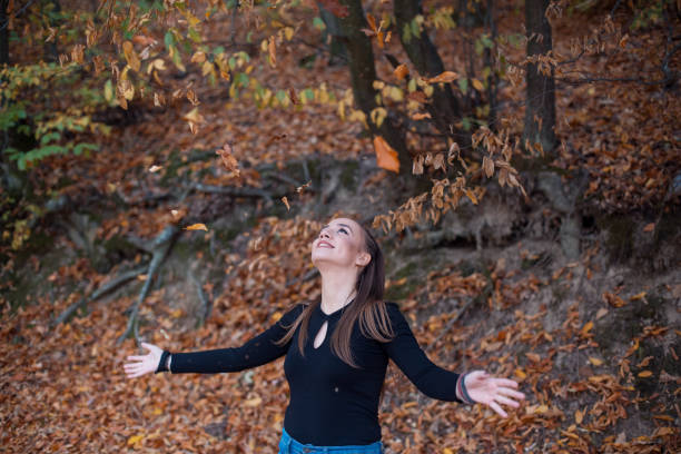 Content Woman Enjoying Rainy Walk in the Misty Forest