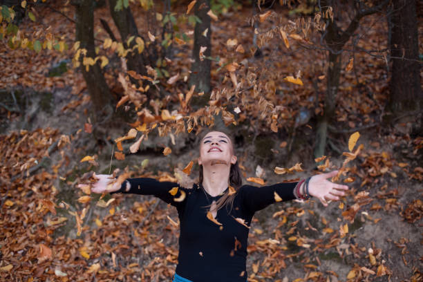 istock Young woman throwing leaves 1063401116