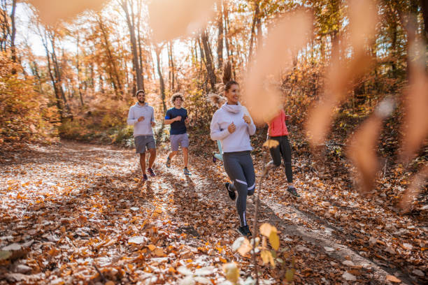 istock Small group of people running in woods. 1063404694