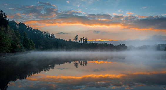 This photograph is taken at Lac de Robertville in Belgium. It was a true magical moment, with the mysterious mist above the water surface and the amazing colors in the sky.