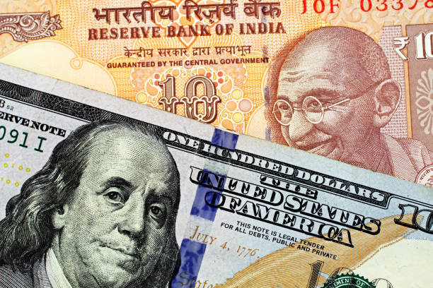 istock An Indian Ten Rupee Bank Note With An American One Hundred Dollar Bill 1063408744