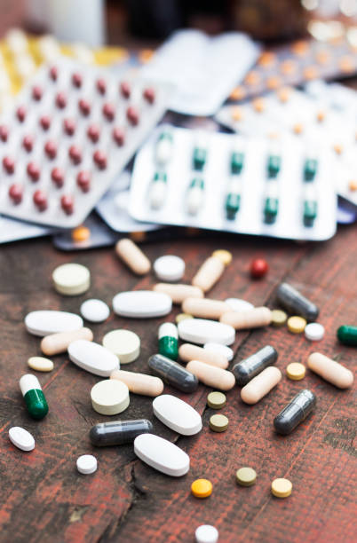 istock Medicines and bottle on wooden table 1063417098