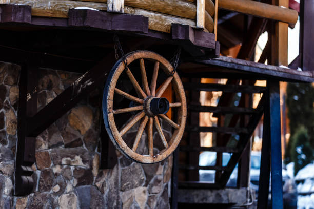istock Wooden wheel and a ladder in low light, wood texture, background for creative design 1063417536