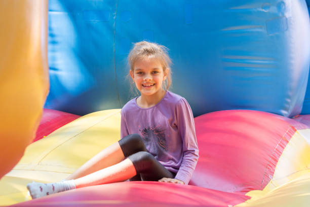 istock The girl sits on a large soft inflatable trampoline 1063417610