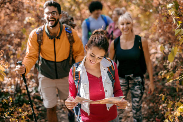 istock Woman leading other hikers in woods. 1063419796