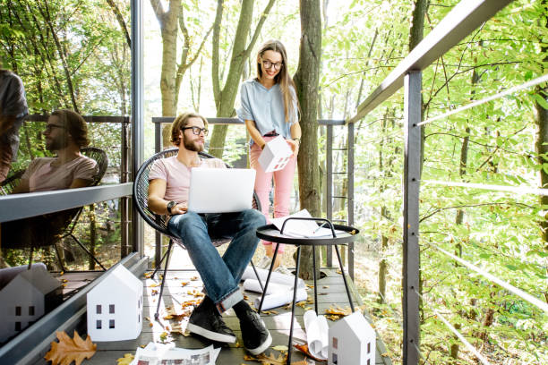 istock Creative couple of architects working outdoors at the forest house 1063420204