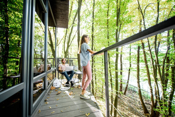 Creative couple of architects working outdoors at the forest house