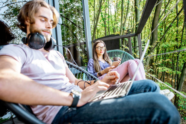 istock Couple wihth gadgets on the balcony in the forest 1063422152