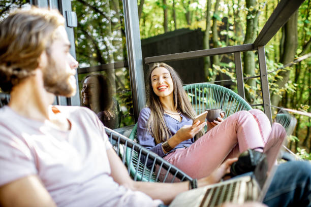 istock Couple wihth gadgets on the balcony in the forest 1063422186