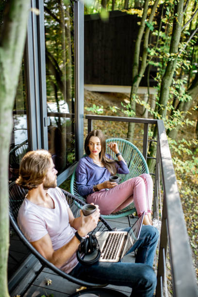 istock Couple wihth gadgets on the balcony in the forest 1063422308
