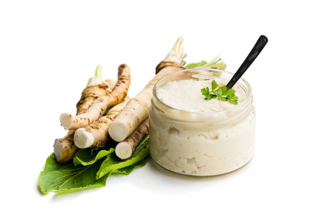 Spicy horseradish sauce in glass jar isolated on white Spicy  horseradish sauce in glass jar isolated on white horseradish stock pictures, royalty-free photos & images