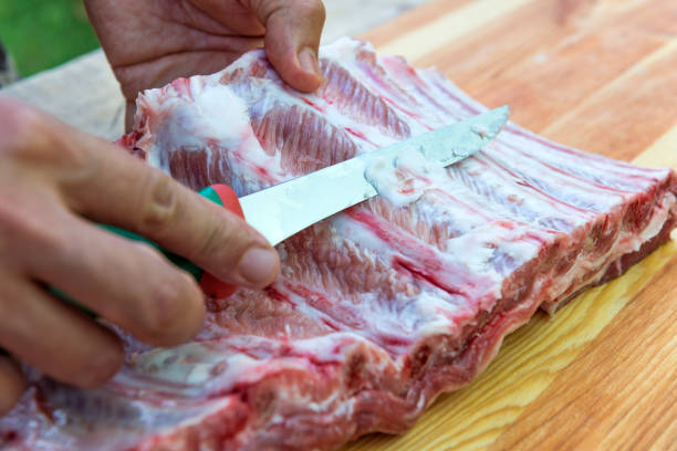 istock Butcher prepares pork ribs for cooking 1063427330