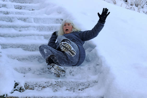 istock A woman slipped and fell on a wintry staircase. Fall on smooth steps 1063428084