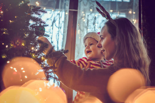 istock Cute boy and his mother near Christmas tree 1063432600