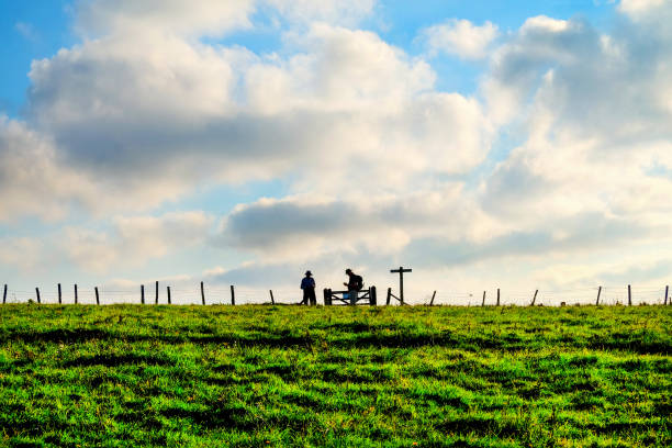 Silhouette scene of a couple enjoy with their drone at sunset on the top of Mt. Eden, Auckland, New Zealand.
