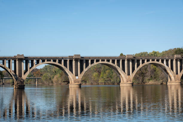 istock Closeup view of bridge over a river with reflections 1063439266