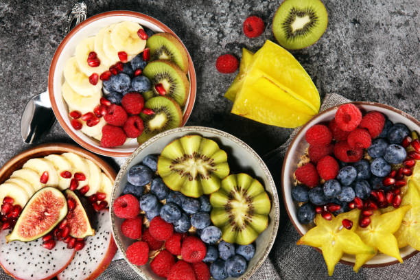 istock fruit bowl. Bowl of healthy fresh fruit salad on rustic background 1063444762