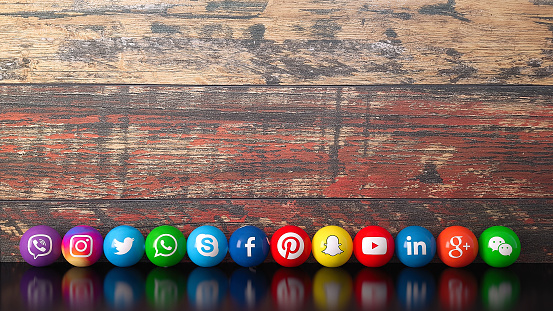 Istanbul, Turkey - November 04, 2018: Sphere shape of popular social media services icons, including Facebook, Instagram, Youtube, Twitter, Whatsapp, Linkedin, Snapchat, Pinterest, Viber, Google, Wechat, Skype on a wooden desk