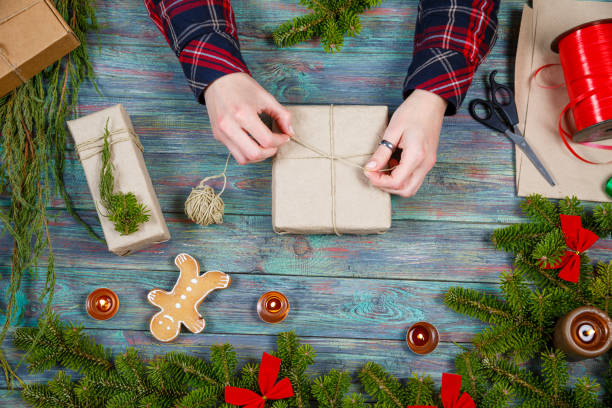 istock Making craft creative gift boxes, woman decorating Christmas presents with natural decorations 1063449546