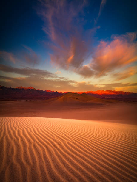 Death Valley sand dune at dusk This is a photograph of Death Valley sand dune with colorful clouds in California, USA death valley desert photos stock pictures, royalty-free photos & images