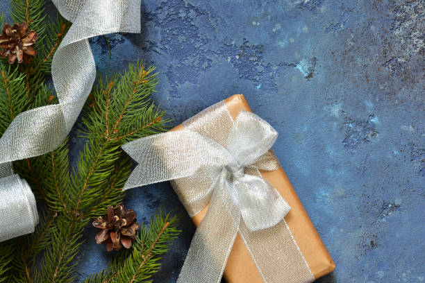 istock Christmas blue background with gift boxes and xmas tree. Christmas tree decoration and copy space for your text 1063449970