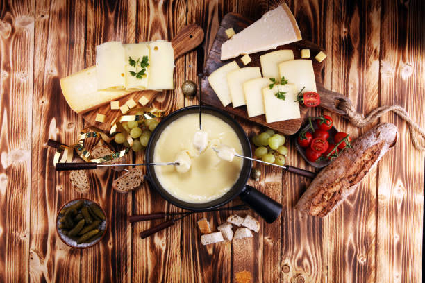 istock Gourmet Swiss fondue dinner on a winter evening with assorted cheese 1063452466