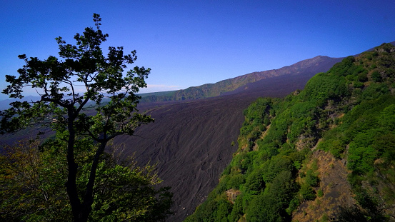 View of the petrified lava flow at the slopes of the volcano Etna, Italy.