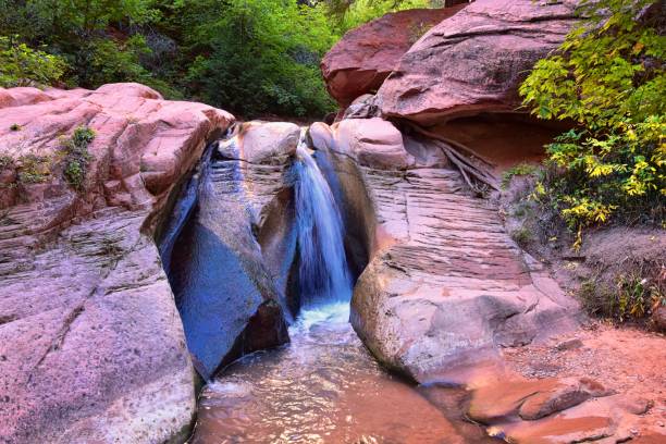 Kanarraville Falls, views from along the hiking trail of falls, stream, river, sandstone cliff formations Waterfall in Kanarra Creek Canyon by Zion National Park, Utah, USA. stock photo