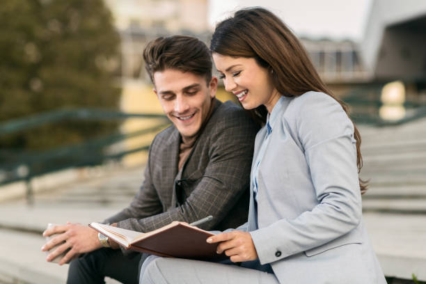 istock Two young business colleagues talking about work outdoors 1063456638